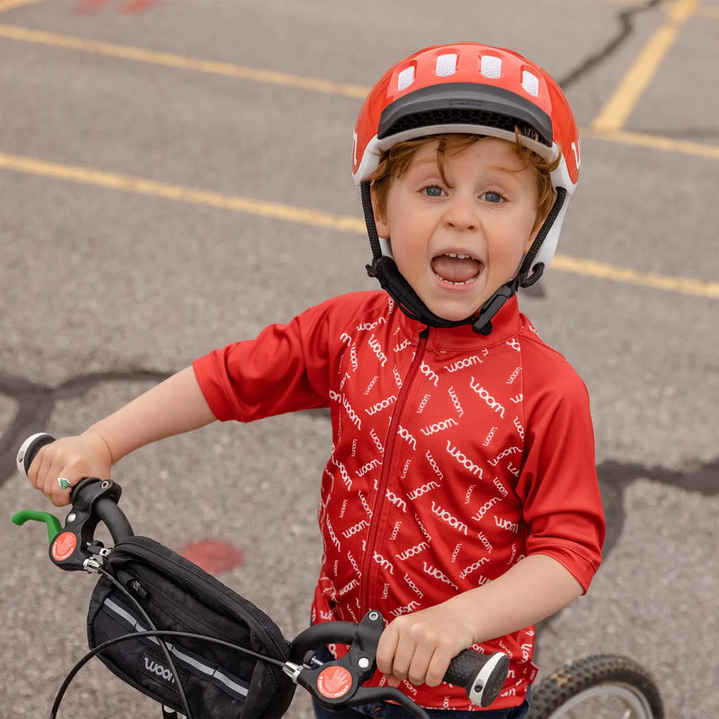 Woom PACE Cycling Jersey - Boy rider wearing red jersey and red Woom helmet