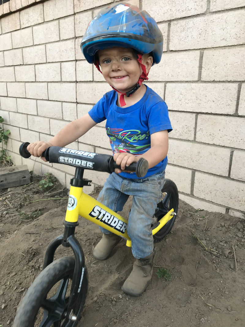 Strider 12 Sport Yellow with Kid Riding